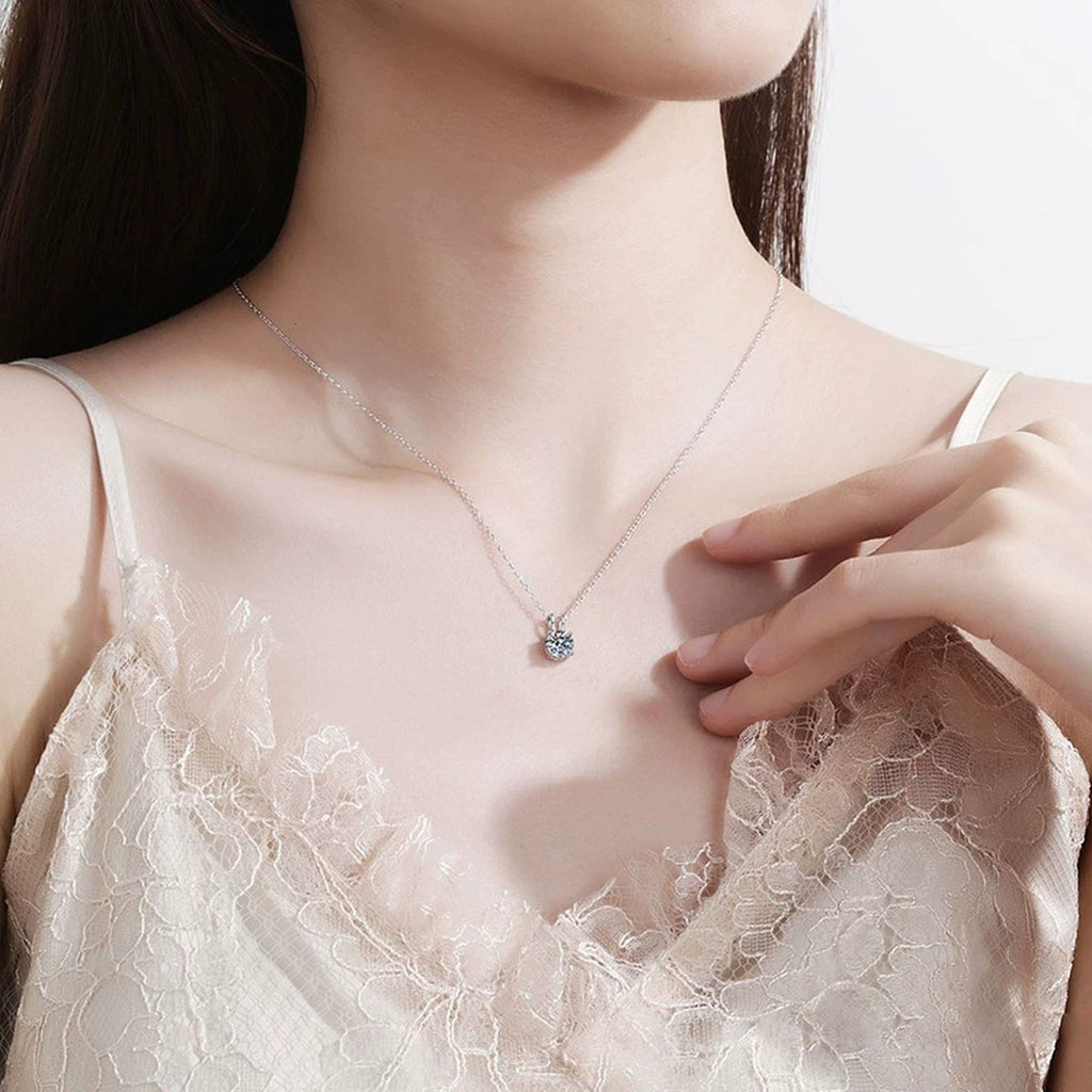 Round Solitaire Moissanite Pendant Necklace in Platinum-Plated S925 Sterling Silver worn on neckline by model