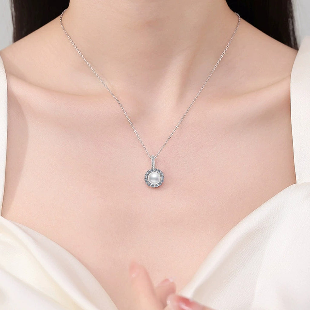 Round Halo Moissanite Freshwater Pearl Pendant Necklace with Cubic Zirconia in White Gold-Plated S925 Sterling Silver worn on neckline by model