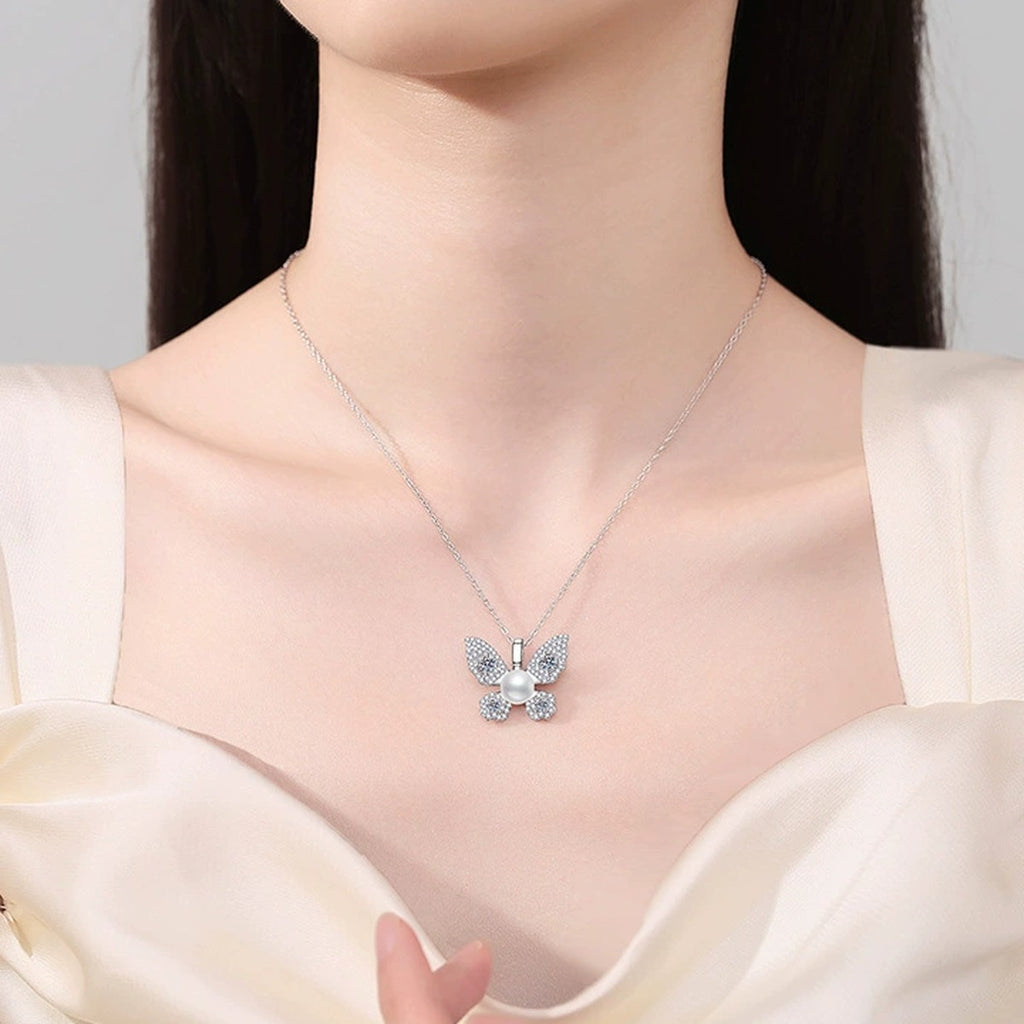 Butterfly Moissanite Freshwater Pearl Pendant Necklace with Cubic Zirconia in White Gold-Plated S925 Sterling Silver worn on neckline by model