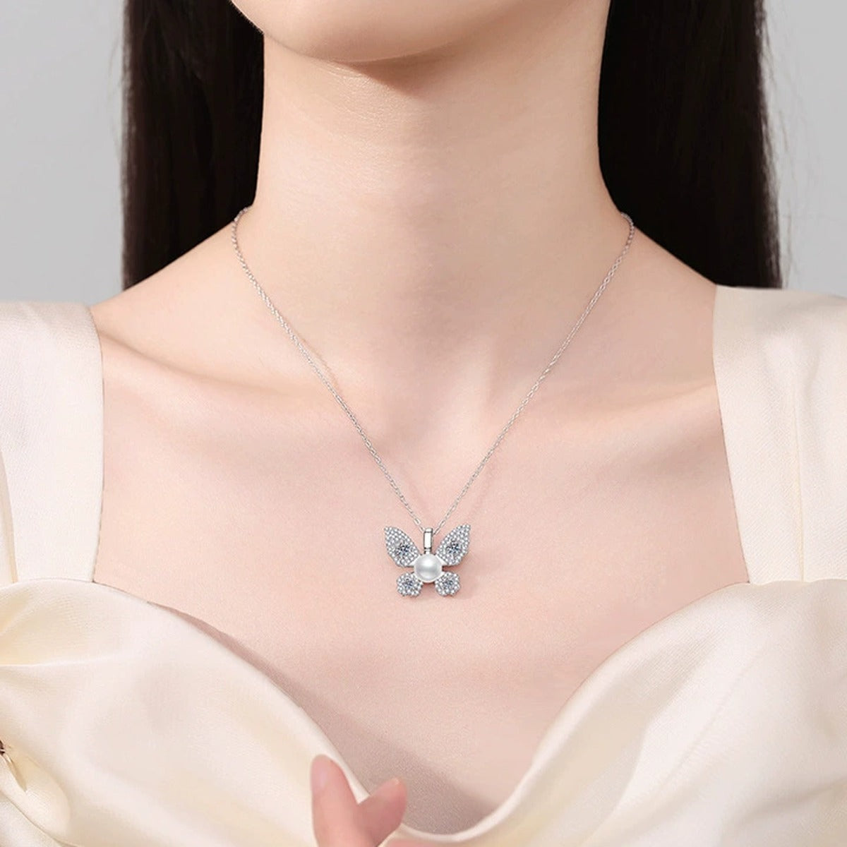 Butterfly Moissanite Freshwater Pearl Pendant Necklace with Cubic Zirconia in White Gold-Plated S925 Sterling Silver worn on neckline by model