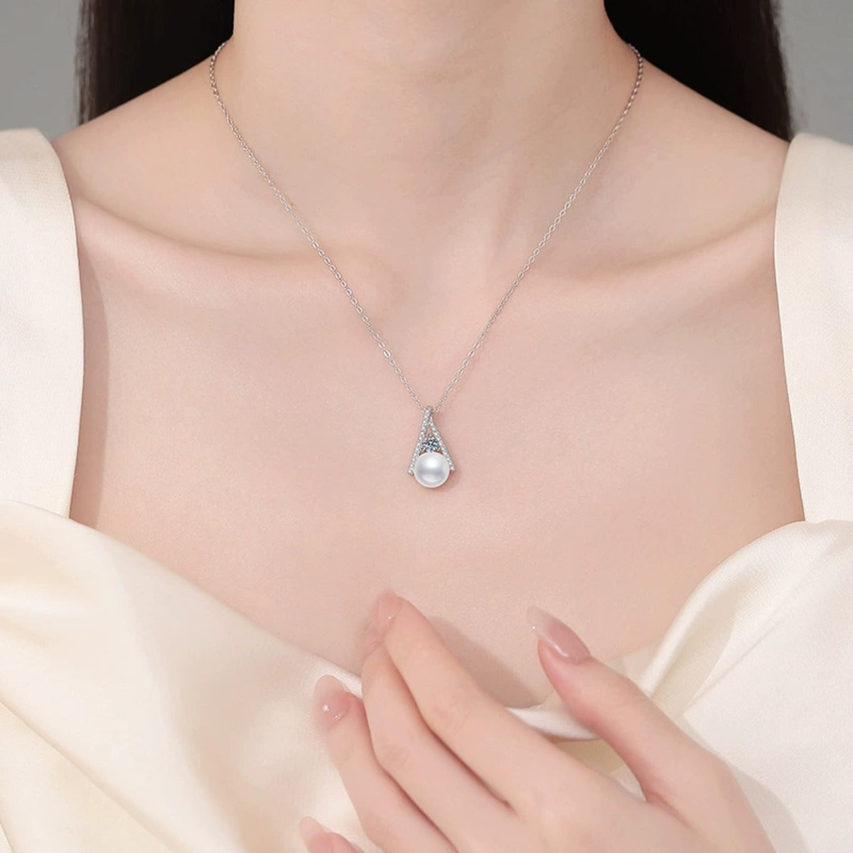 Triangle Moissanite Freshwater Pearl Pendant Necklace with Cubic Zirconia in White Gold-Plated S925 Sterling Silver worn on neckline by model