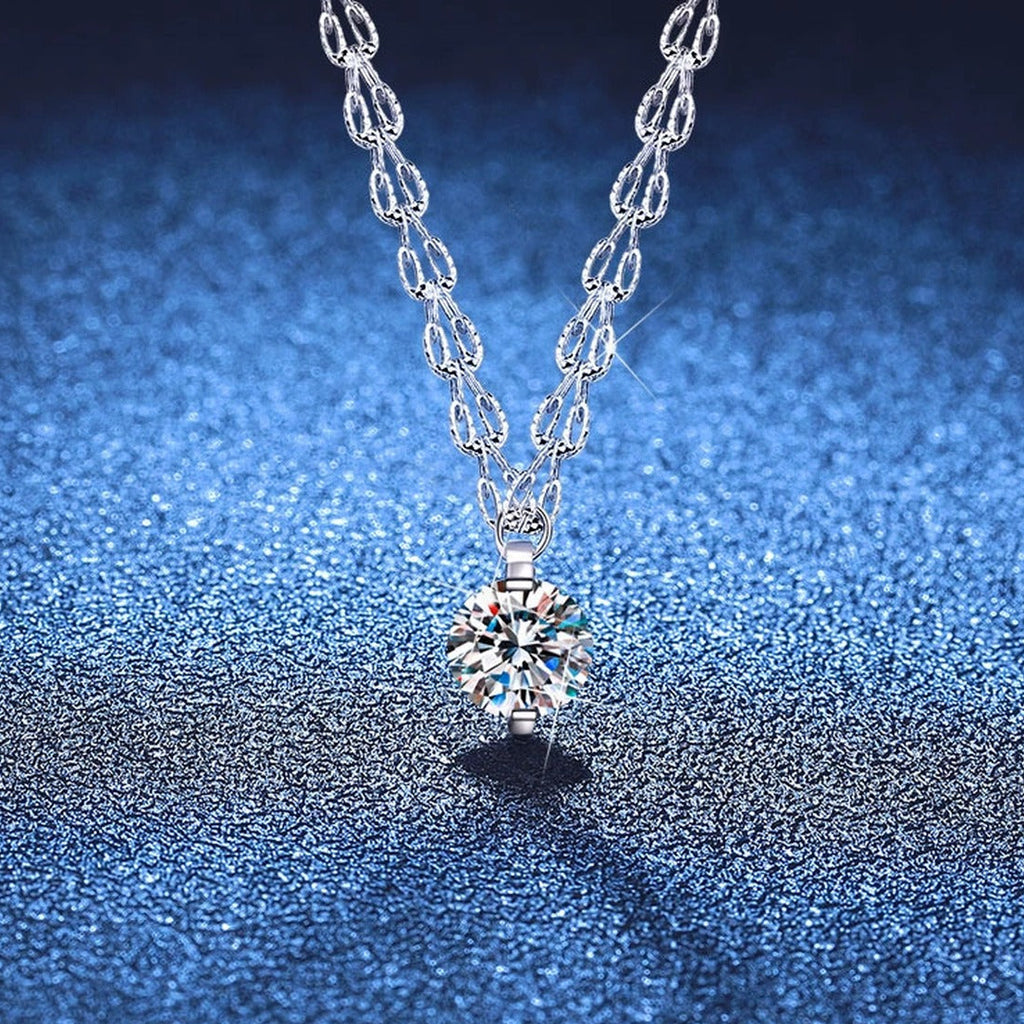 Round Moissanite Pendant Necklace in White Gold-Plated S925 Sterling Silver blue background angled view