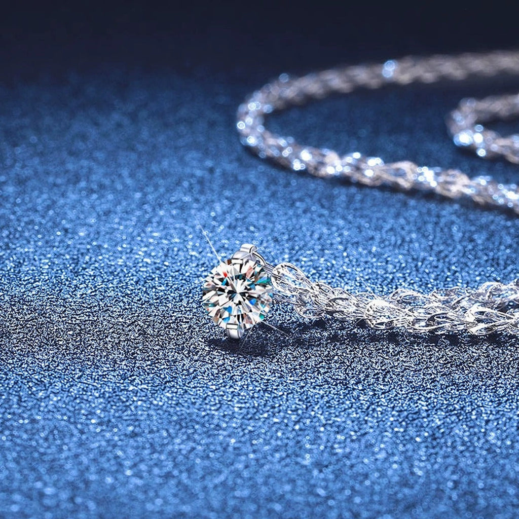 Round Moissanite Pendant Necklace in White Gold-Plated S925 Sterling Silver blue background close-up view