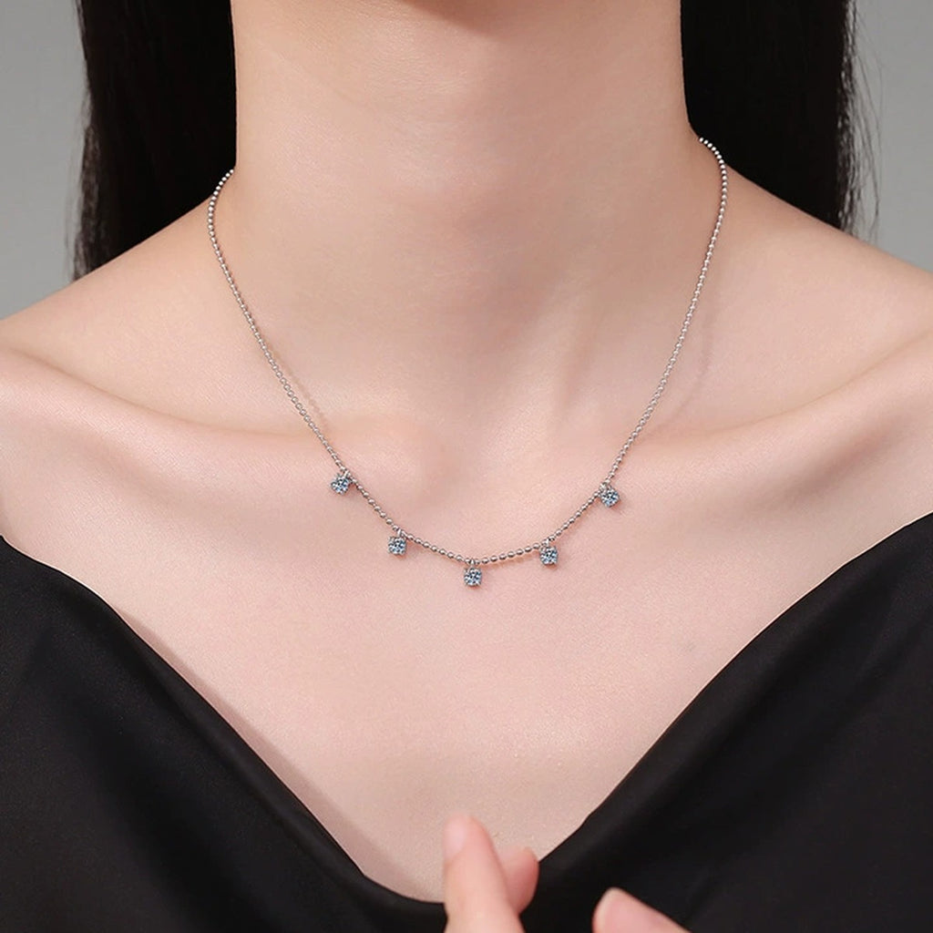Five-Stone Station Moissanite Necklace in Platinum-Plated S925 Sterling Silver worn on neckline by model