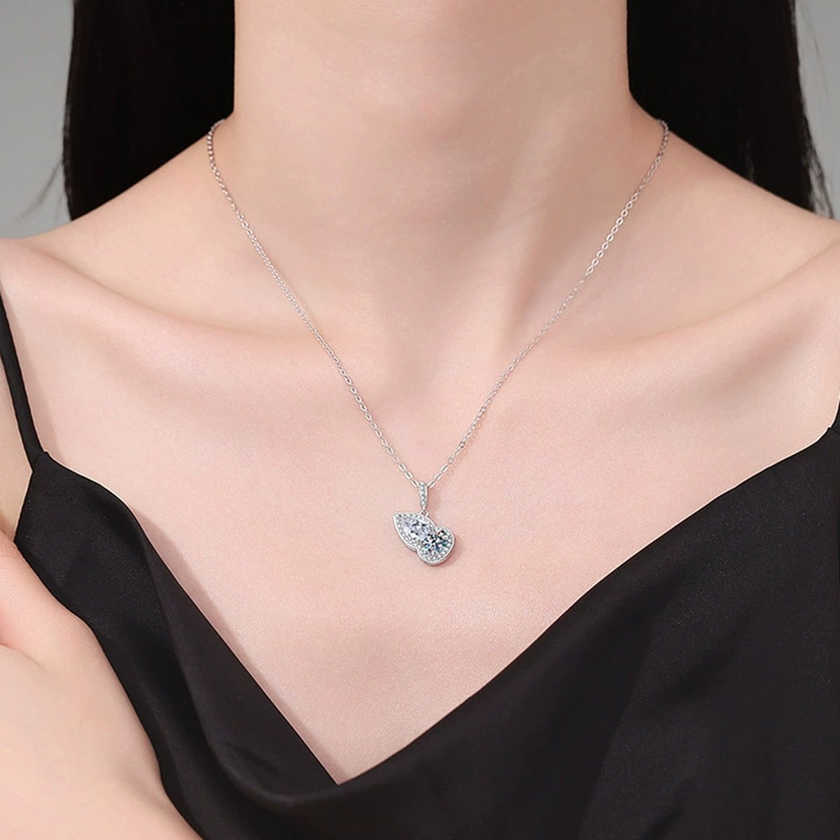 Two-Stone Pear Moissanite Pendant Necklace with Cubic Zirconia in Platinum-Plated S925 Sterling Silver worn on neckline by model