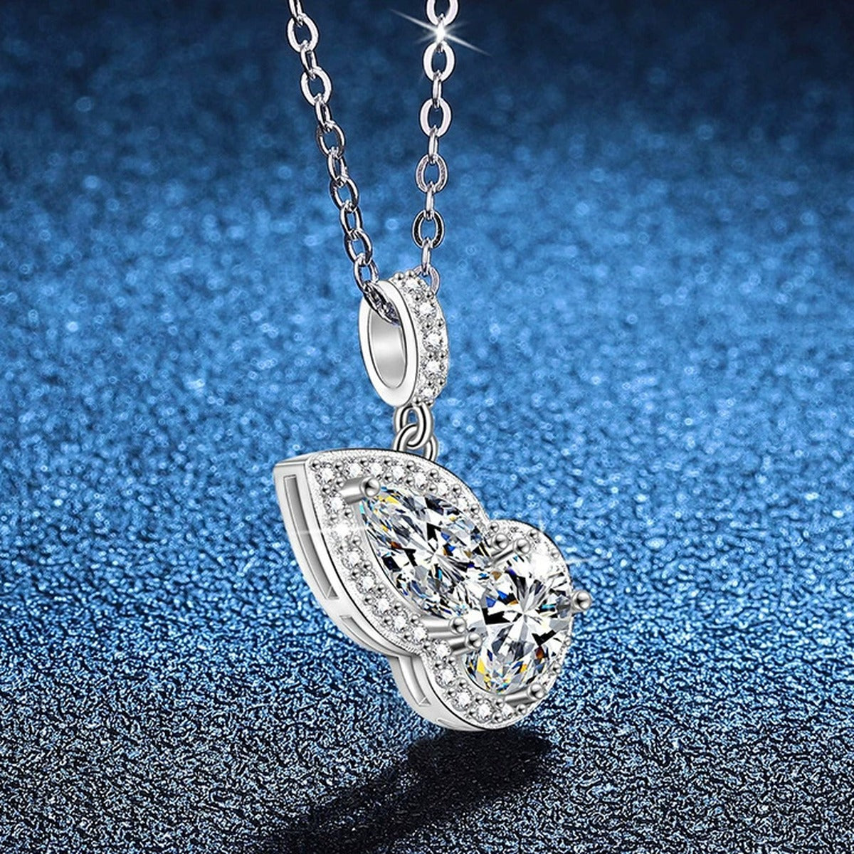 Two-Stone Pear Moissanite Pendant Necklace with Cubic Zirconia in Platinum-Plated S925 Sterling Silver blue background close-up view