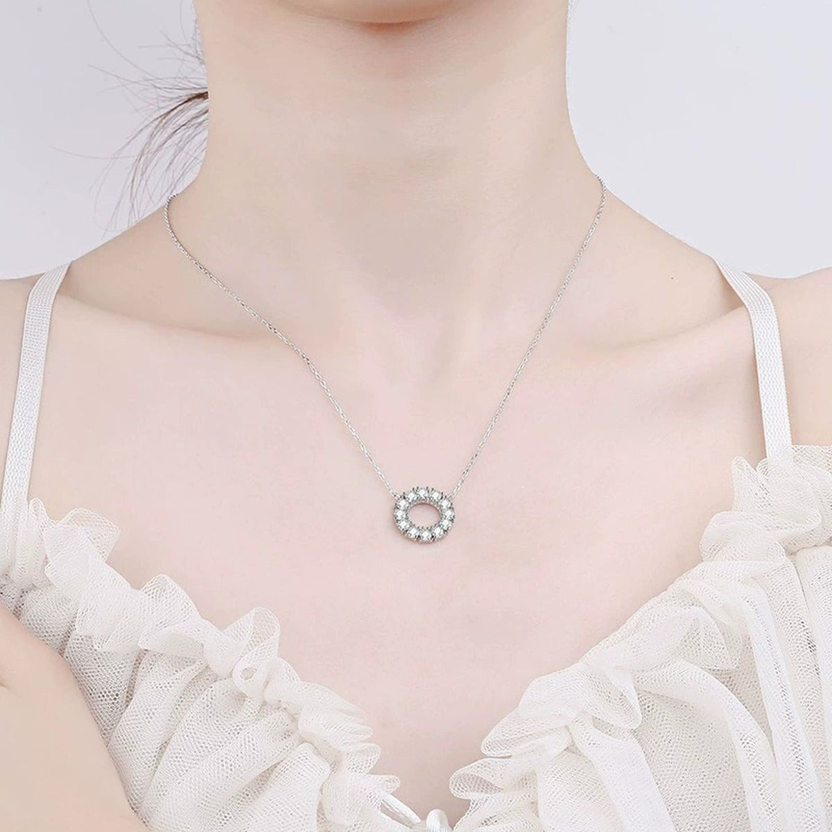 Circle Moissanite Pendant Necklace in Platinum-Plated S925 Sterling Silver worn on neckline by model
