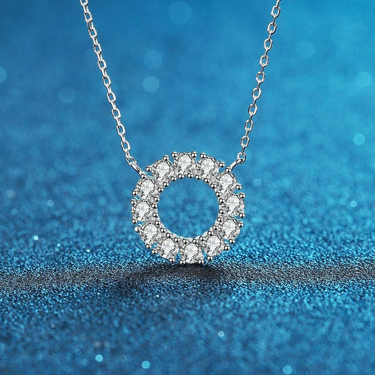 Circle Moissanite Pendant Necklace in Platinum-Plated S925 Sterling Silver blue background close-up view