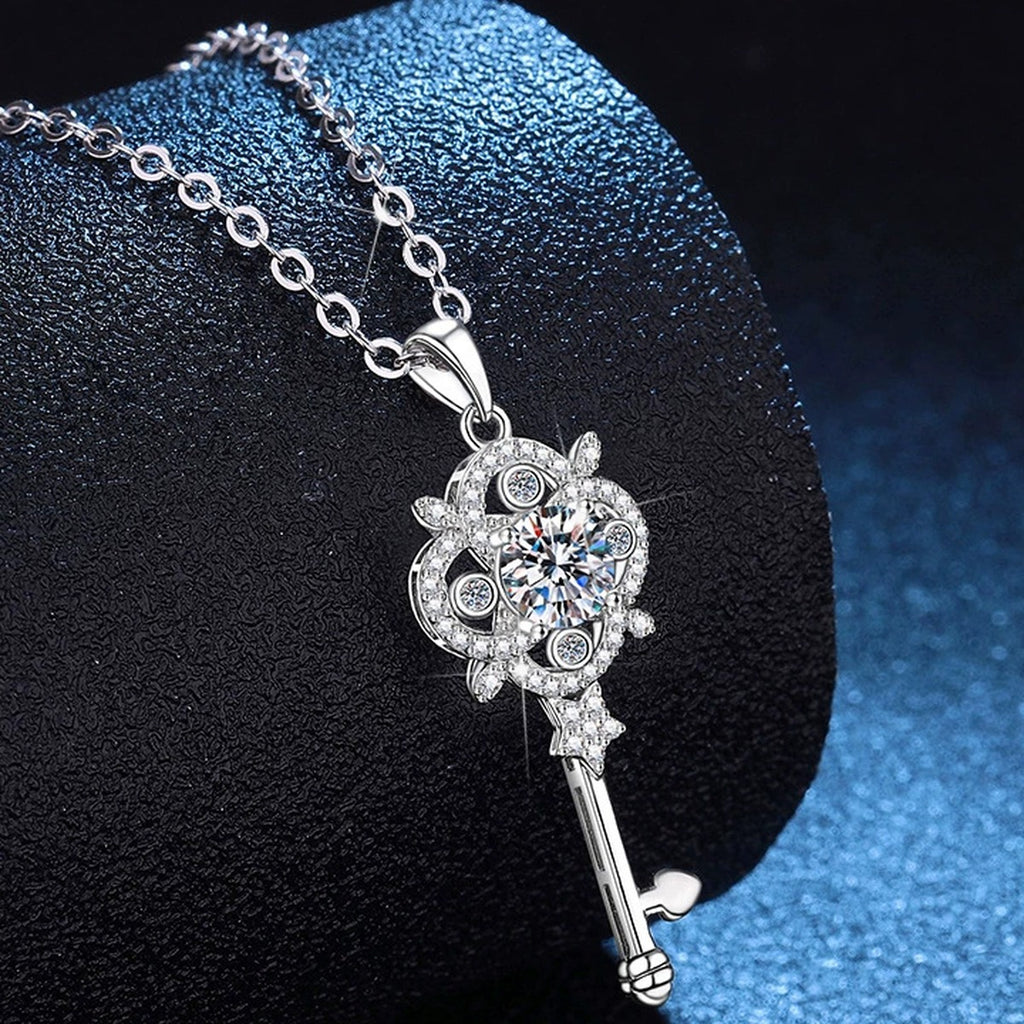 Ornate Key Moissanite Pendant Necklace with Cubic Zirconia in Platinum-Plated S925 Sterling Silver blue background angled view