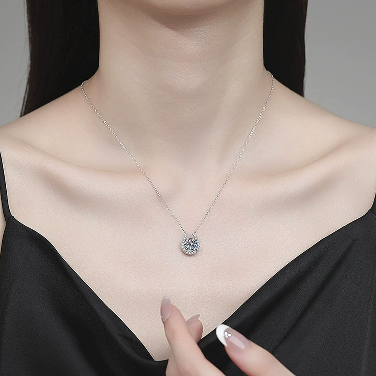 Pear Halo Moissanite Pendant Necklace with Cubic Zirconia in Platinum-Plated S925 Sterling Silver worn on neckline by model