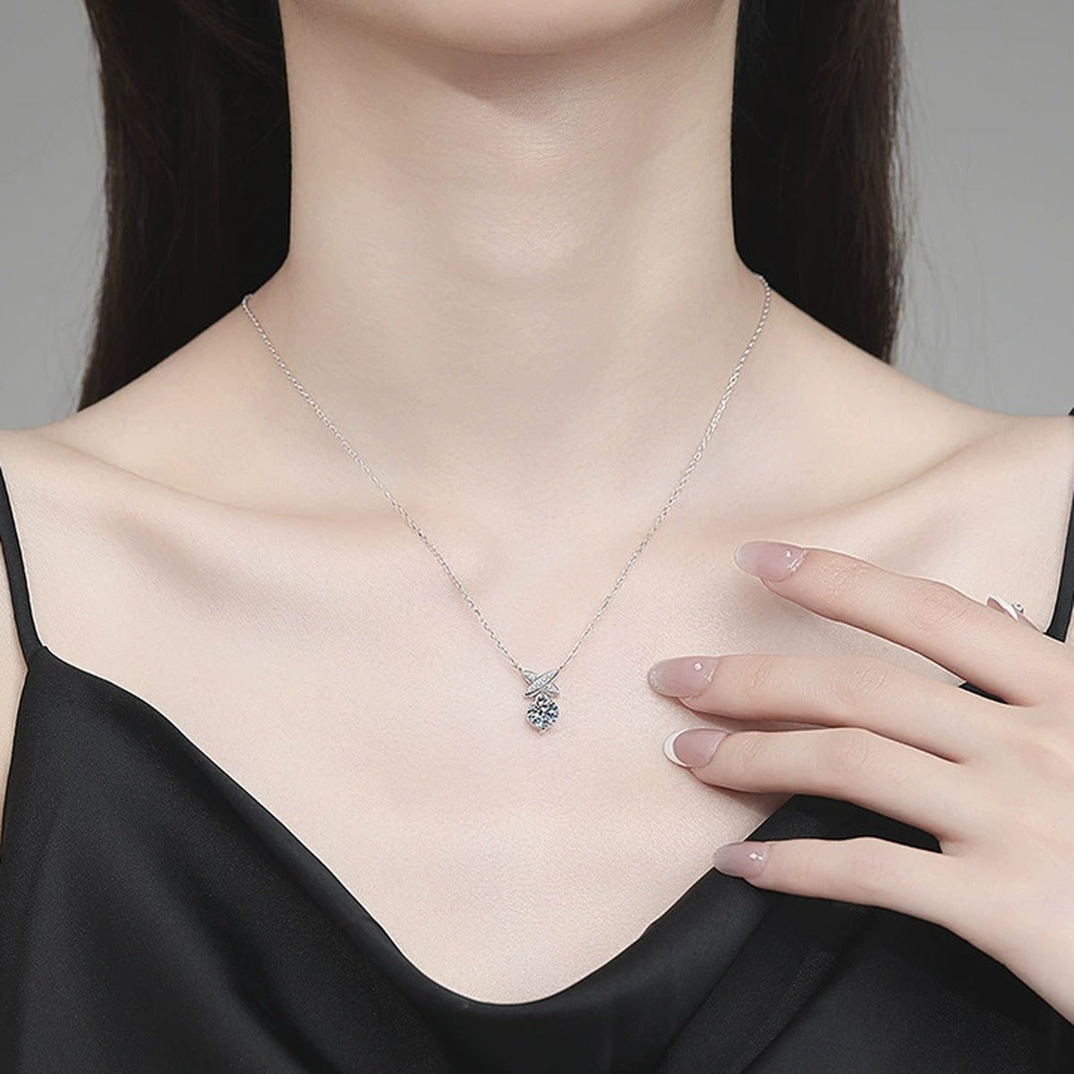 Ribbon Drop Moissanite Pendant Necklace with Cubic Zirconia in Platinum-Plated S925 Sterling Silver worn on neckline by model