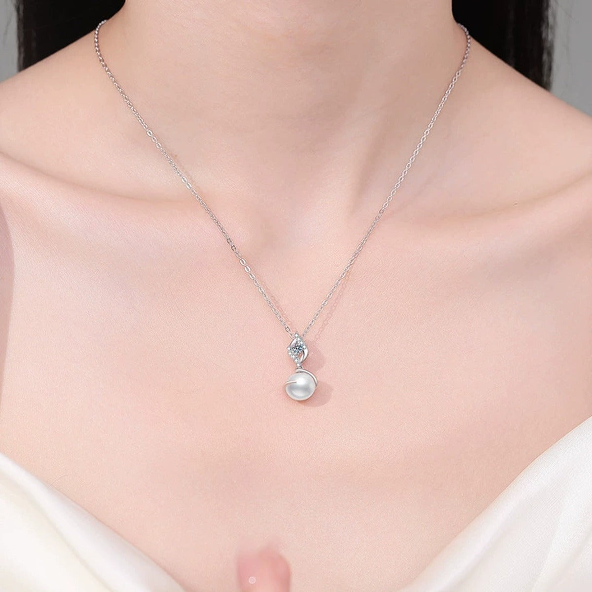 Swirl Moissanite Freshwater Pearl Pendant Necklace with Cubic Zirconia in White Gold-Plated S925 Sterling Silver worn on neckline by model