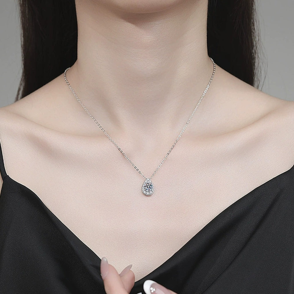 Pear Halo Moissanite Pendant Necklace with Cubic Zirconia in Platinum-Plated S925 Sterling Silver worn on neckline by model