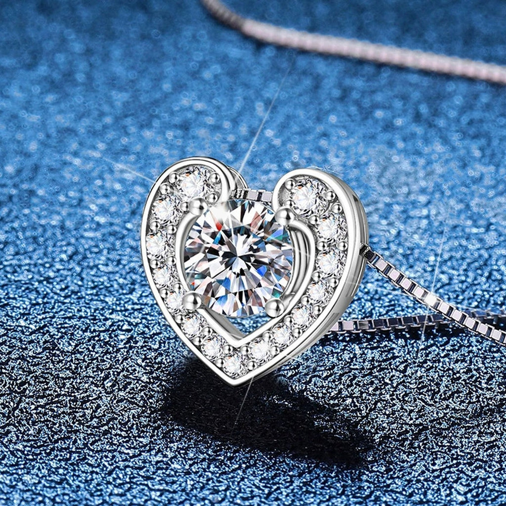 Heart Moissanite Pendant Necklace with Box Chain in Platinum-Plated S925 Sterling Silver blue background angled view