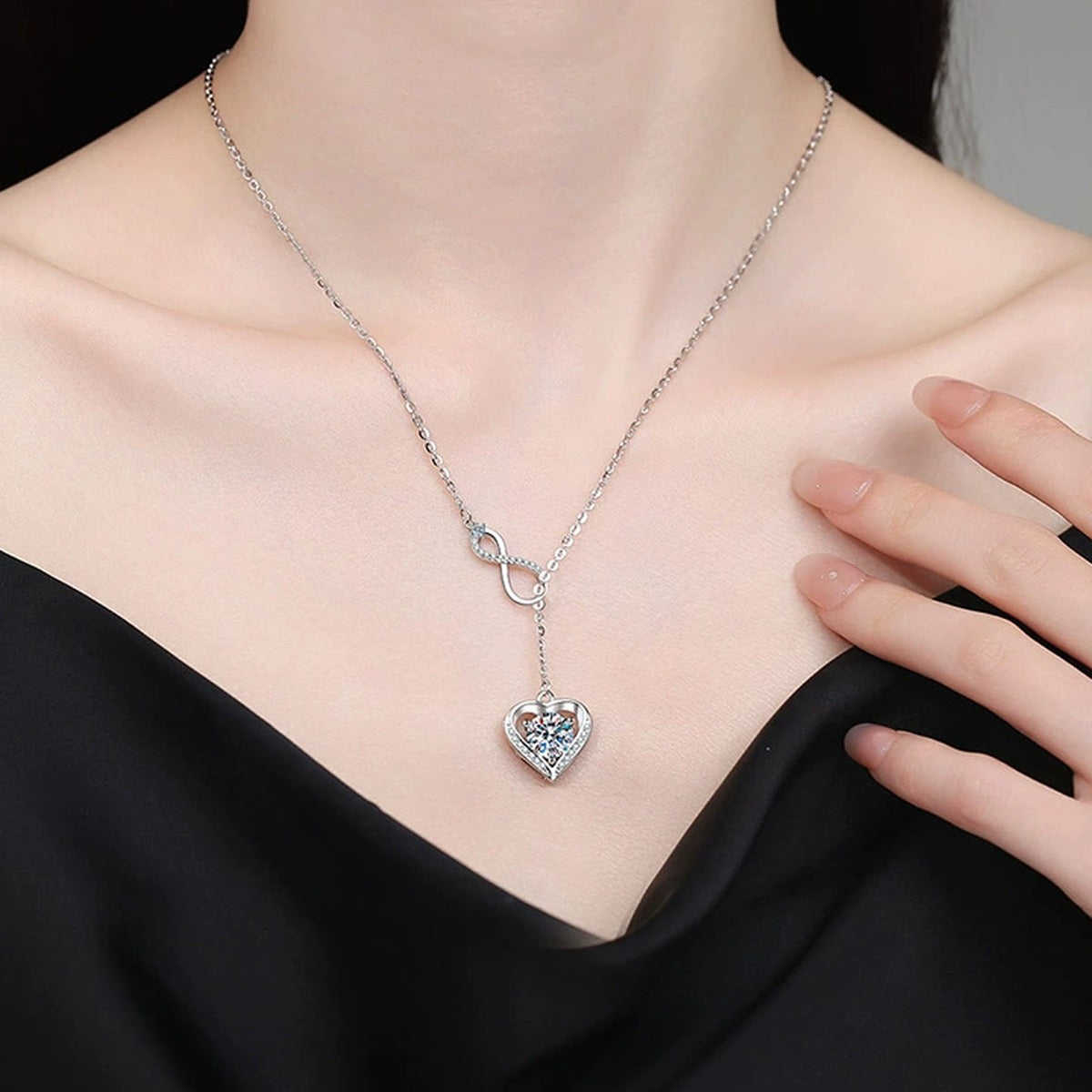 Infinity Heart Moissanite Pendant Necklace with Cubic Zirconia in Platinum-Plated S925 Sterling Silver worn on neckline by model