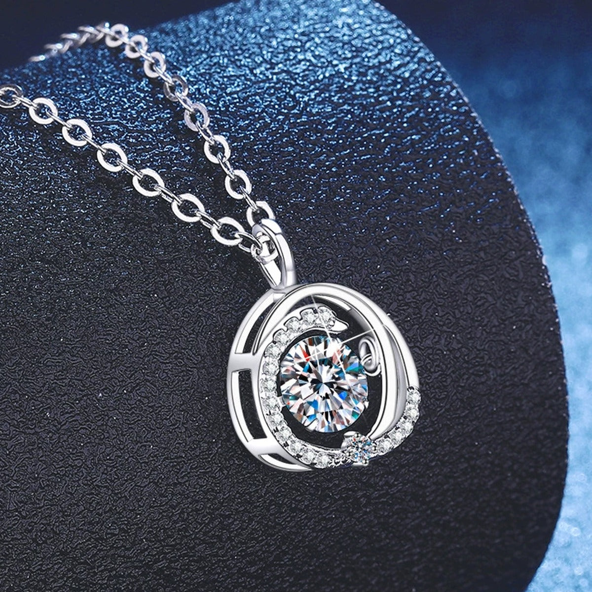Round Swirl Moissanite Pendant Necklace with Cubic Zirconia in Platinum-Plated S925 Sterling Silver blue background angled view
