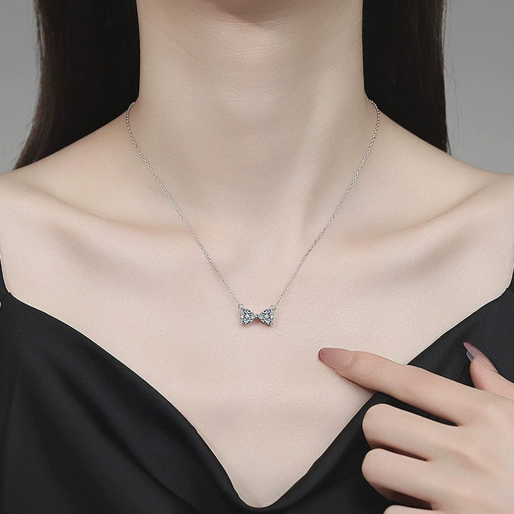 Bow Moissanite Necklace in Platinum-Plated S925 Sterling Silver worn on neckline by model