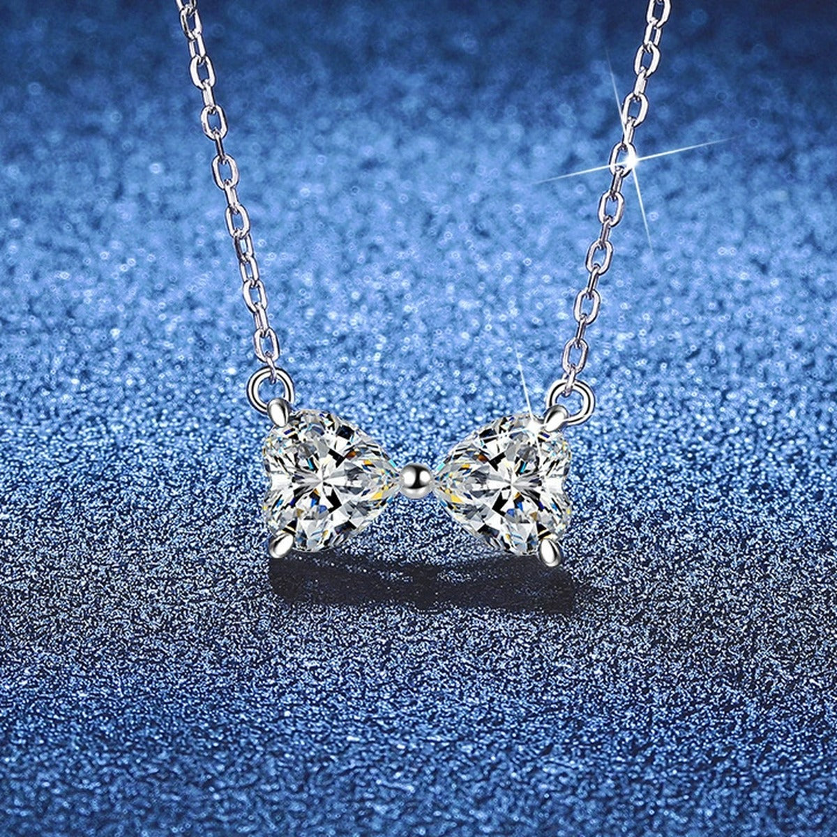 Bow Moissanite Necklace in Platinum-Plated S925 Sterling Silver blue background angled view