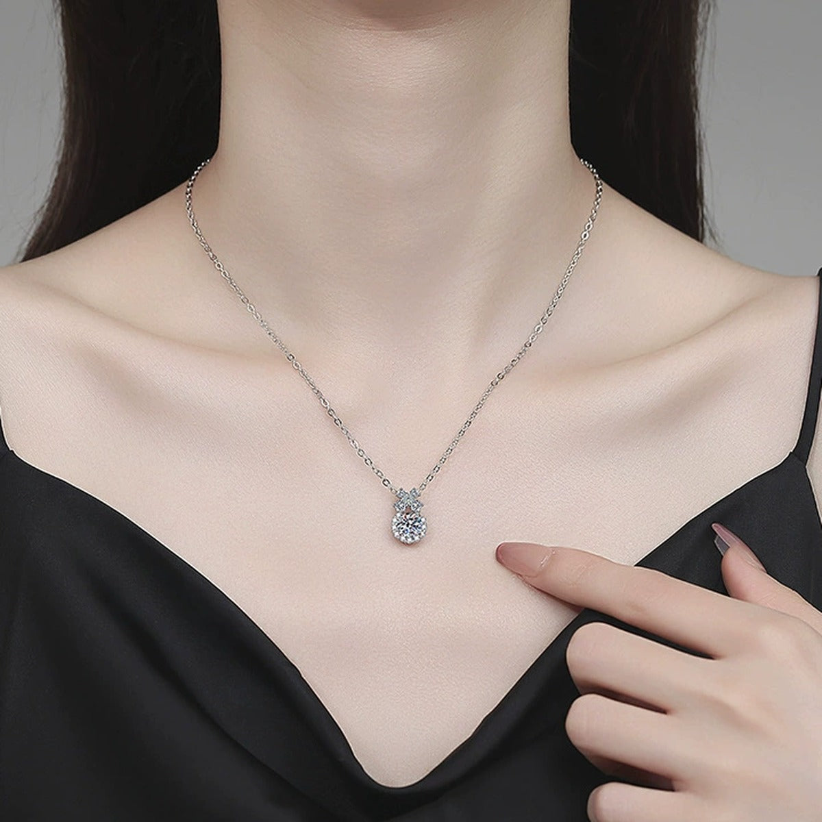 Bow Drop Moissanite Pendant Necklace with Cubic Zirconia in Platinum-Plated S925 Sterling Silver worn on neckline by model