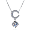 Crescent Moon Moissanite Pendant Necklace with Cubic Zirconia in Platinum-Plated S925 Sterling Silver on clean white background showing the crescent moon pendant above a round moissanite drop