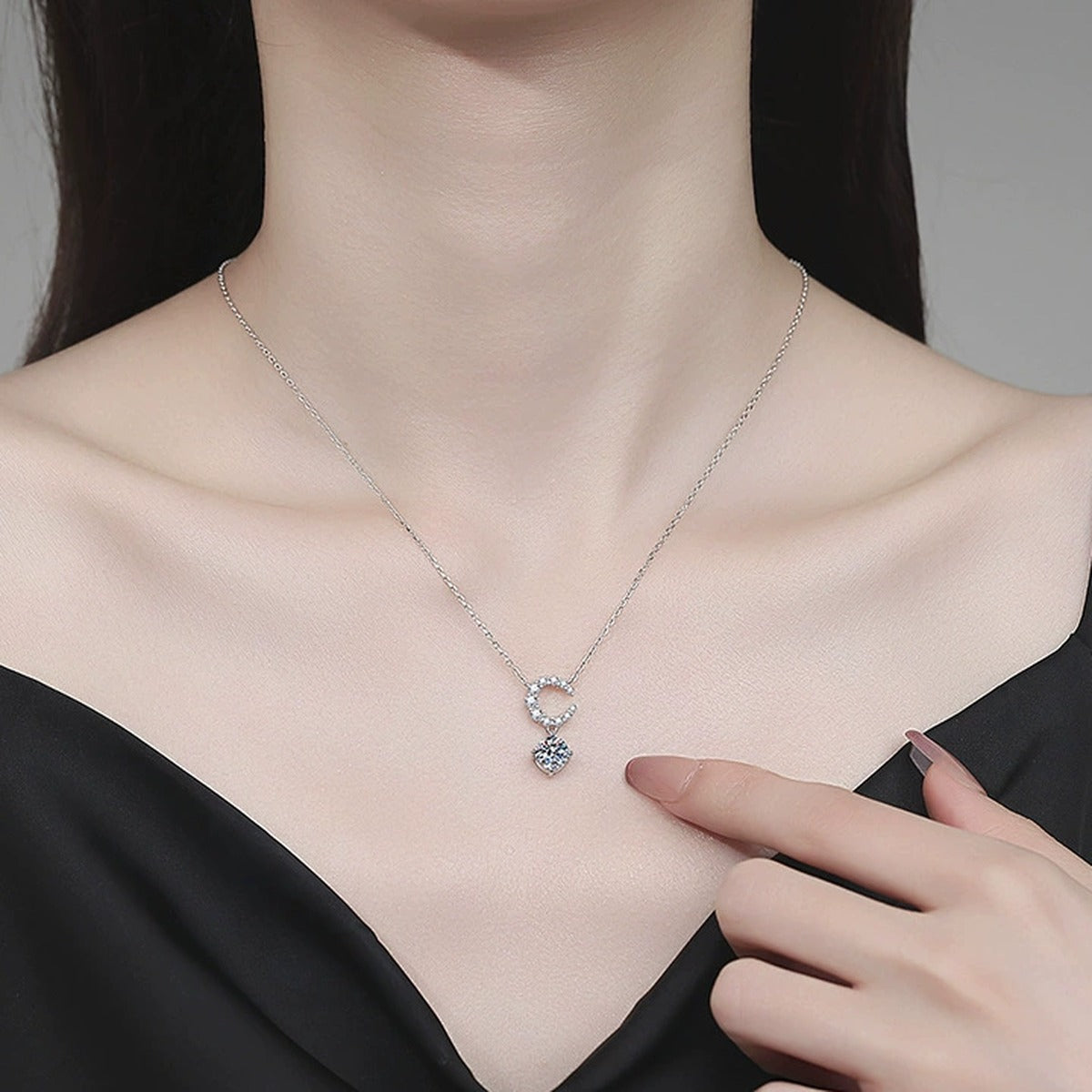 Crescent Moon Moissanite Pendant Necklace with Cubic Zirconia in Platinum-Plated S925 Sterling Silver worn on neckline by model