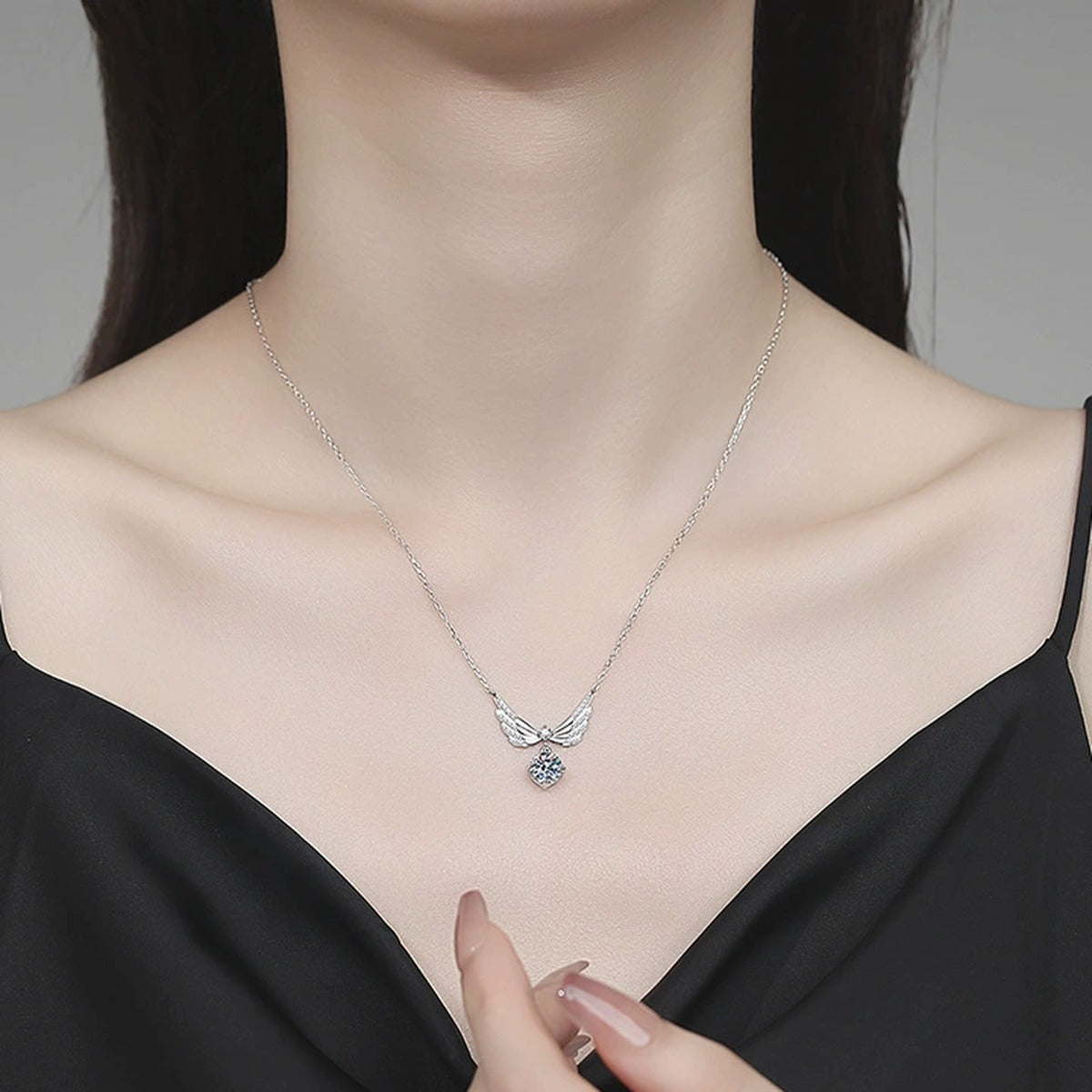Wing Drop Moissanite Pendant Necklace with Cubic Zirconia in Platinum-Plated S925 Sterling Silver worn on neckline by model
