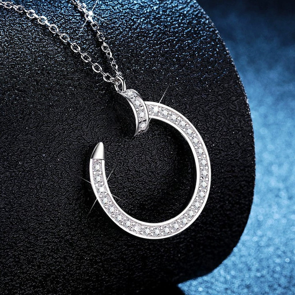 Crescent Moon Moissanite Pendant Necklace in Platinum-Plated S925 Sterling Silver blue background angled view