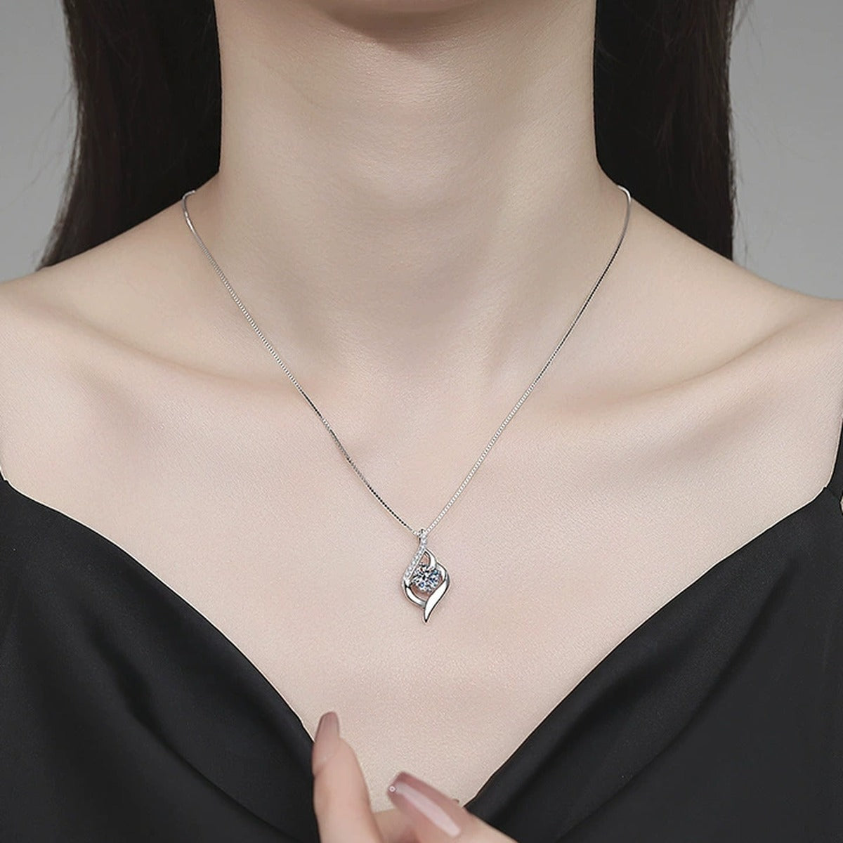 Ribbon Drop Moissanite Pendant Necklace with Cubic Zirconia in Platinum-Plated S925 Sterling Silver worn on neckline by model