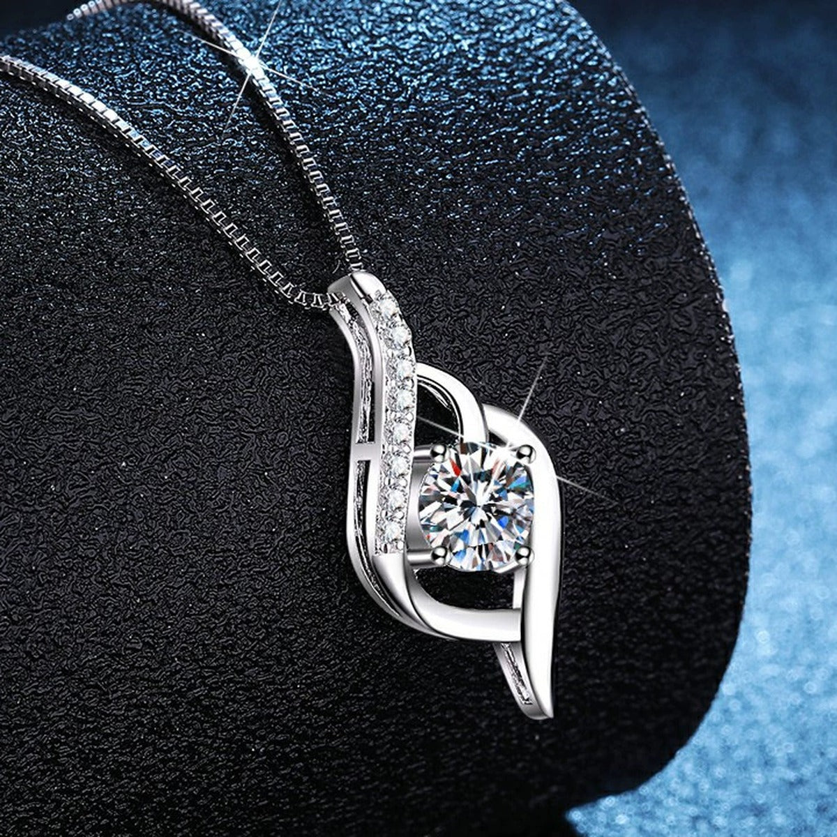 Ribbon Drop Moissanite Pendant Necklace with Cubic Zirconia in Platinum-Plated S925 Sterling Silver blue background angled view