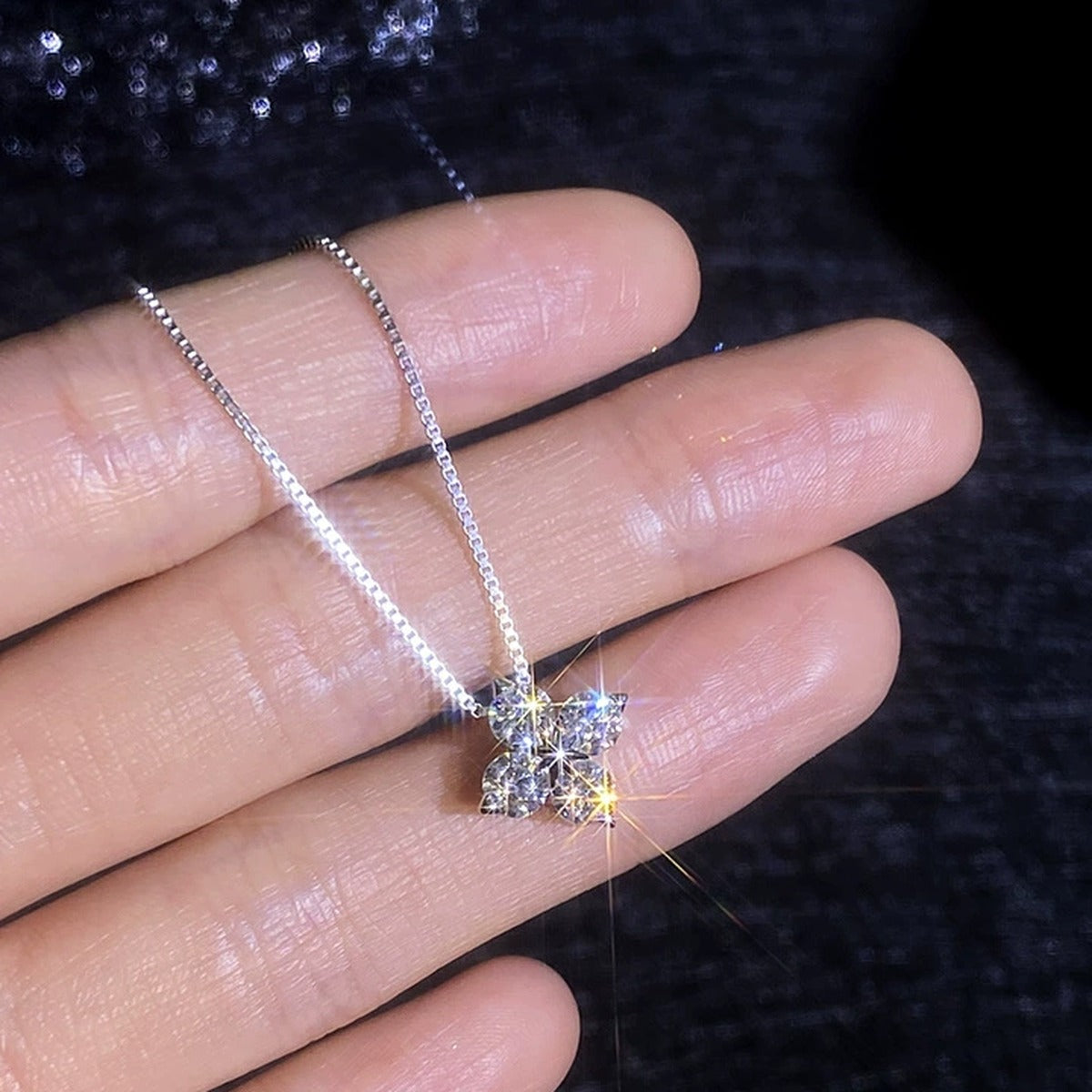 Clover Moissanite Pendant Necklace in Platinum-Plated S925 Sterling Silver worn on neckline by model