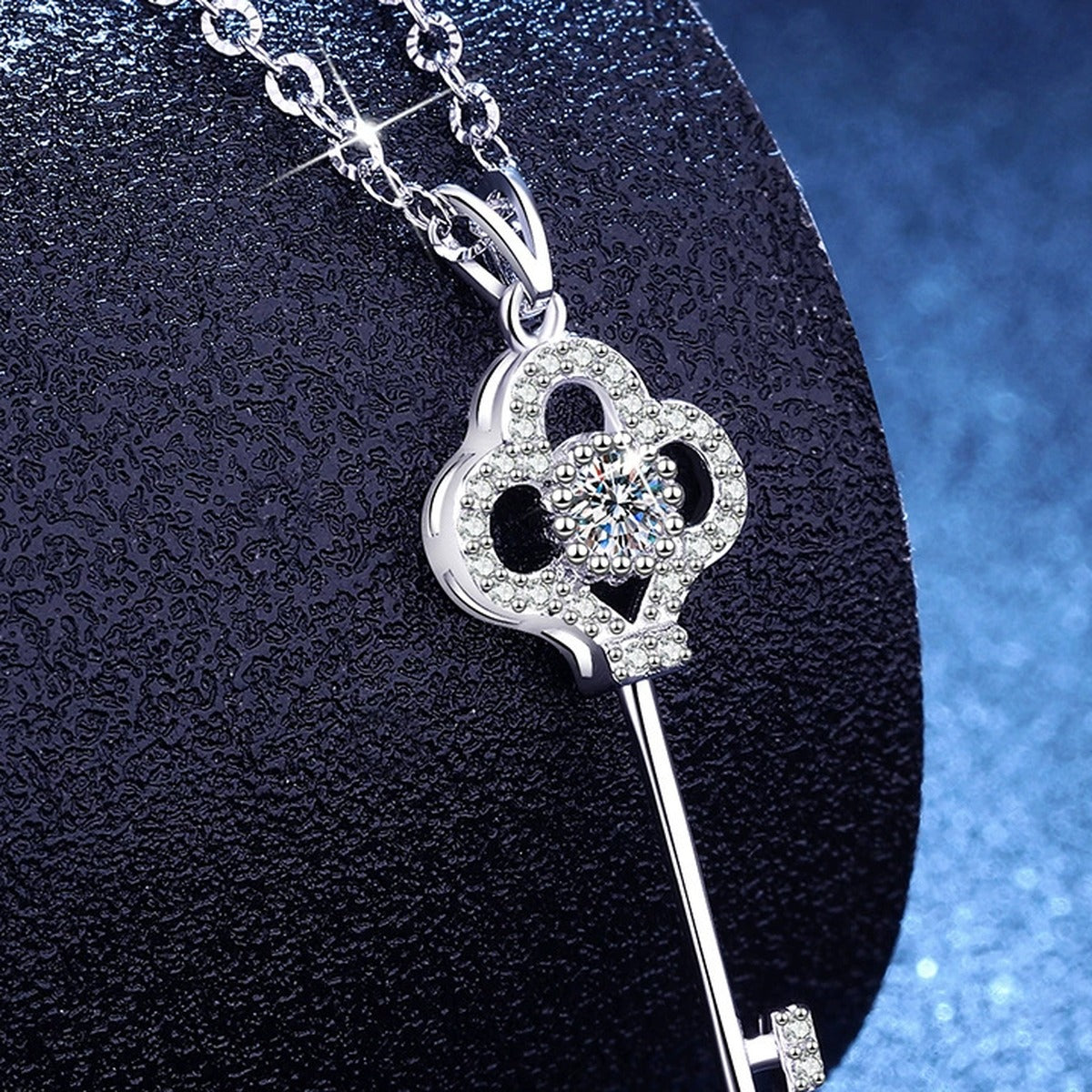 Key Moissanite Pendant Necklace with Cubic Zirconia in Platinum-Plated S925 Sterling Silver blue background angled view
