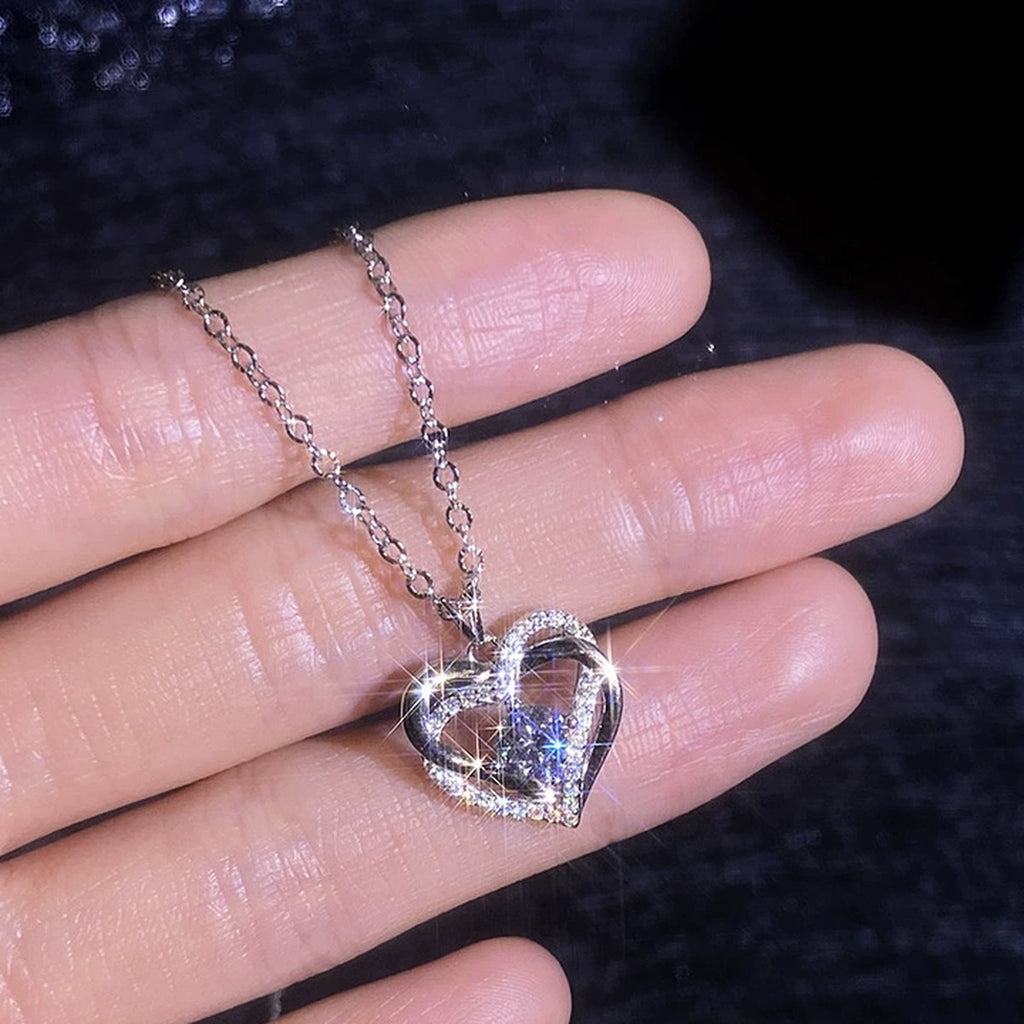 Heart Halo Moissanite Pendant Necklace with Cubic Zirconia in Platinum-Plated S925 Sterling Silver worn on neckline by model