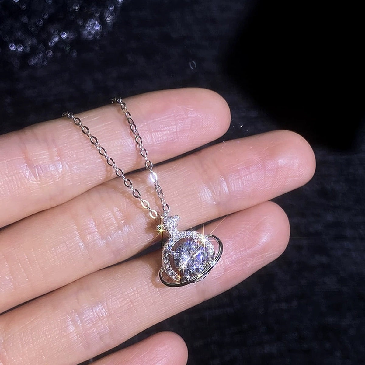 Saturn Halo Moissanite Pendant Necklace with Cubic Zirconia in Platinum-Plated S925 Sterling Silver worn on neckline by model