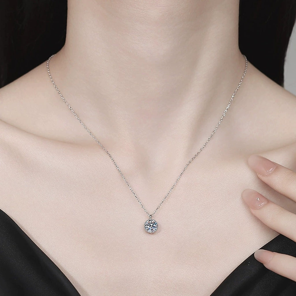 Solitaire Moissanite Pendant Necklace in Platinum-Plated S925 Sterling Silver worn on neckline by model