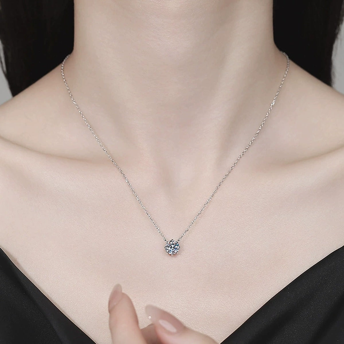 Six-Prong Moissanite Pendant Necklace in Platinum-Plated S925 Sterling Silver worn on neckline by model