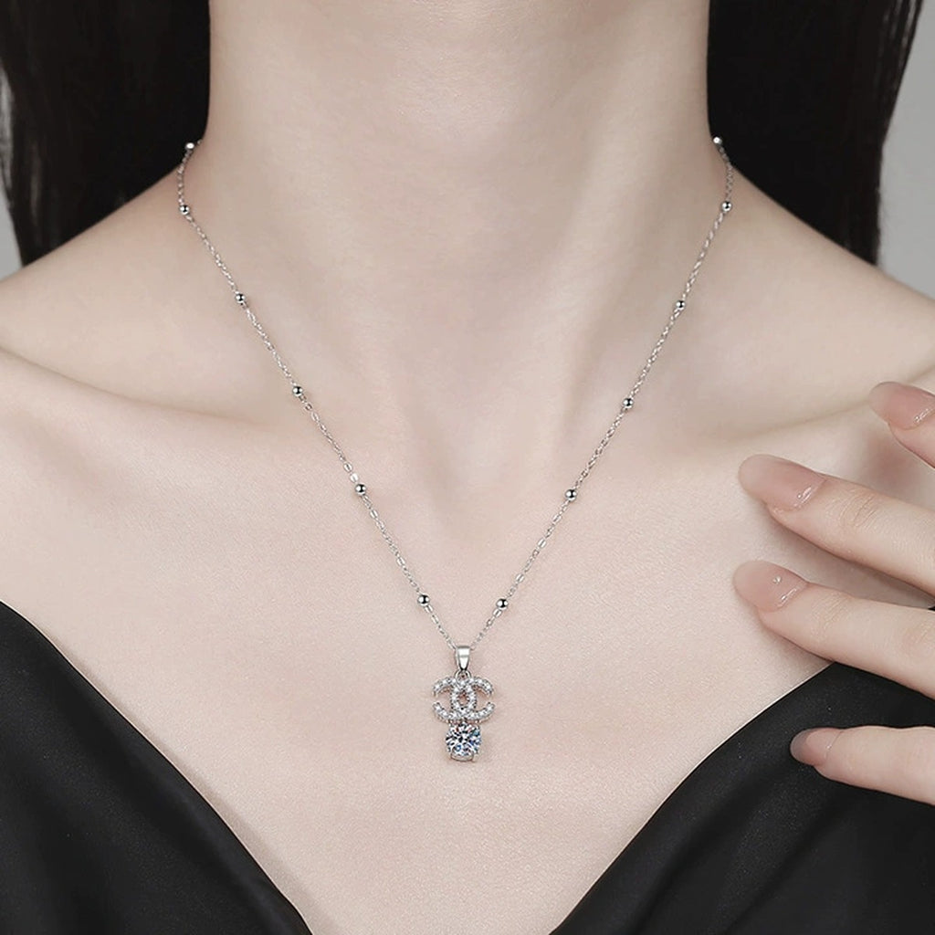 Double-C Pendant Necklace with Cubic Zirconia in Platinum-Plated S925 Sterling Silver worn on neckline by model