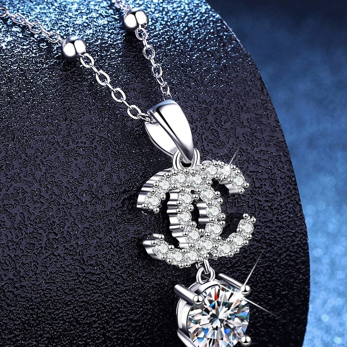 Double-C Pendant Necklace with Cubic Zirconia in Platinum-Plated S925 Sterling Silver blue background product view