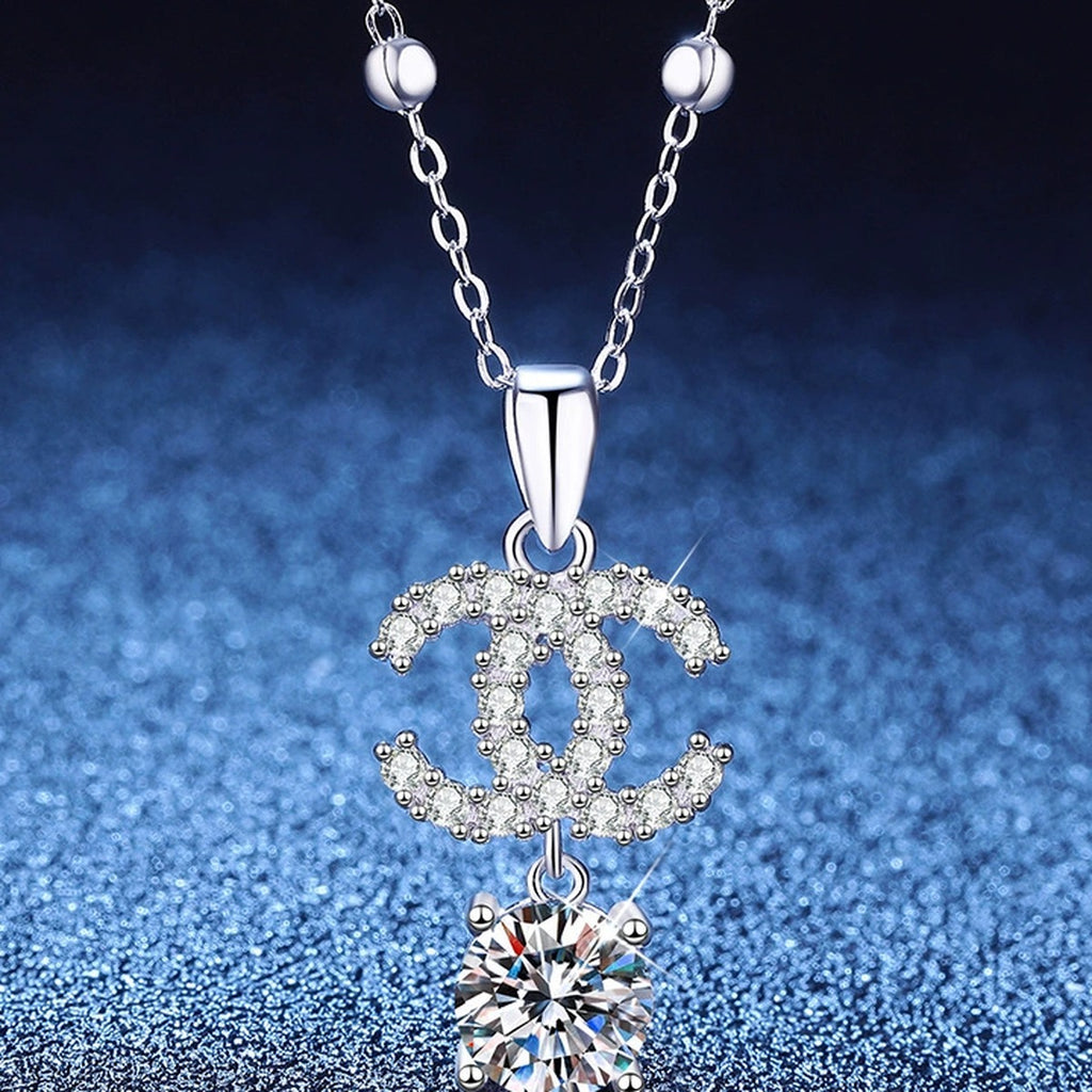 Double-C Pendant Necklace with Cubic Zirconia in Platinum-Plated S925 Sterling Silver blue background angled view