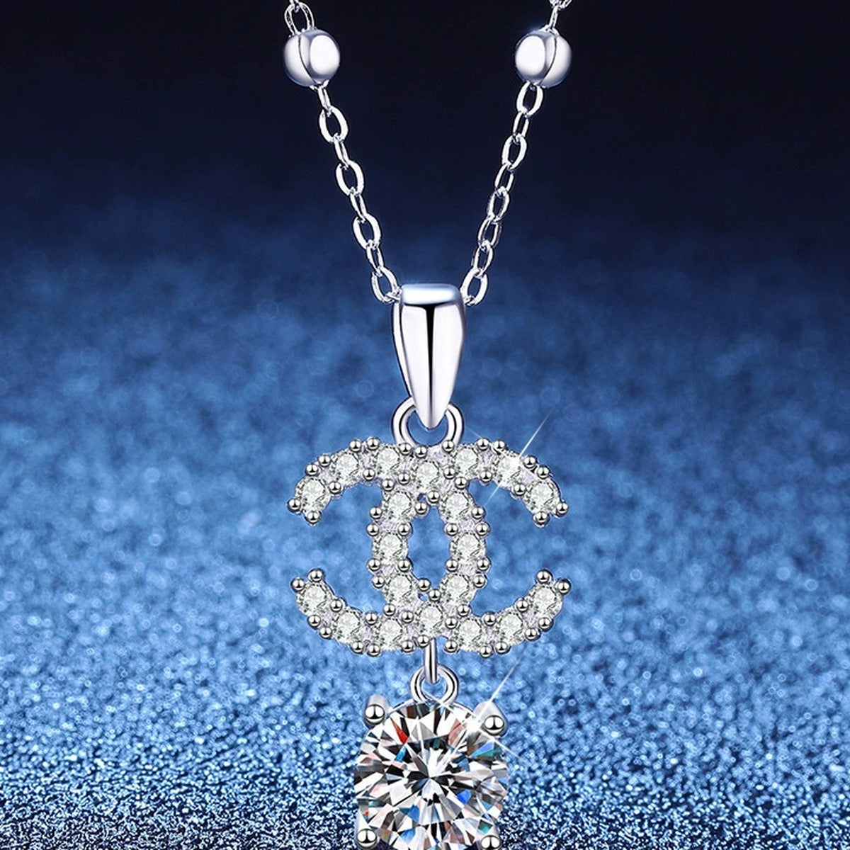 Double-C Pendant Necklace with Cubic Zirconia in Platinum-Plated S925 Sterling Silver blue background angled view