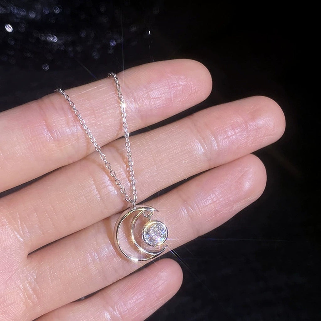 Crescent Moon Moissanite Pendant Necklace in Platinum-Plated S925 Sterling Silver worn on neckline by model