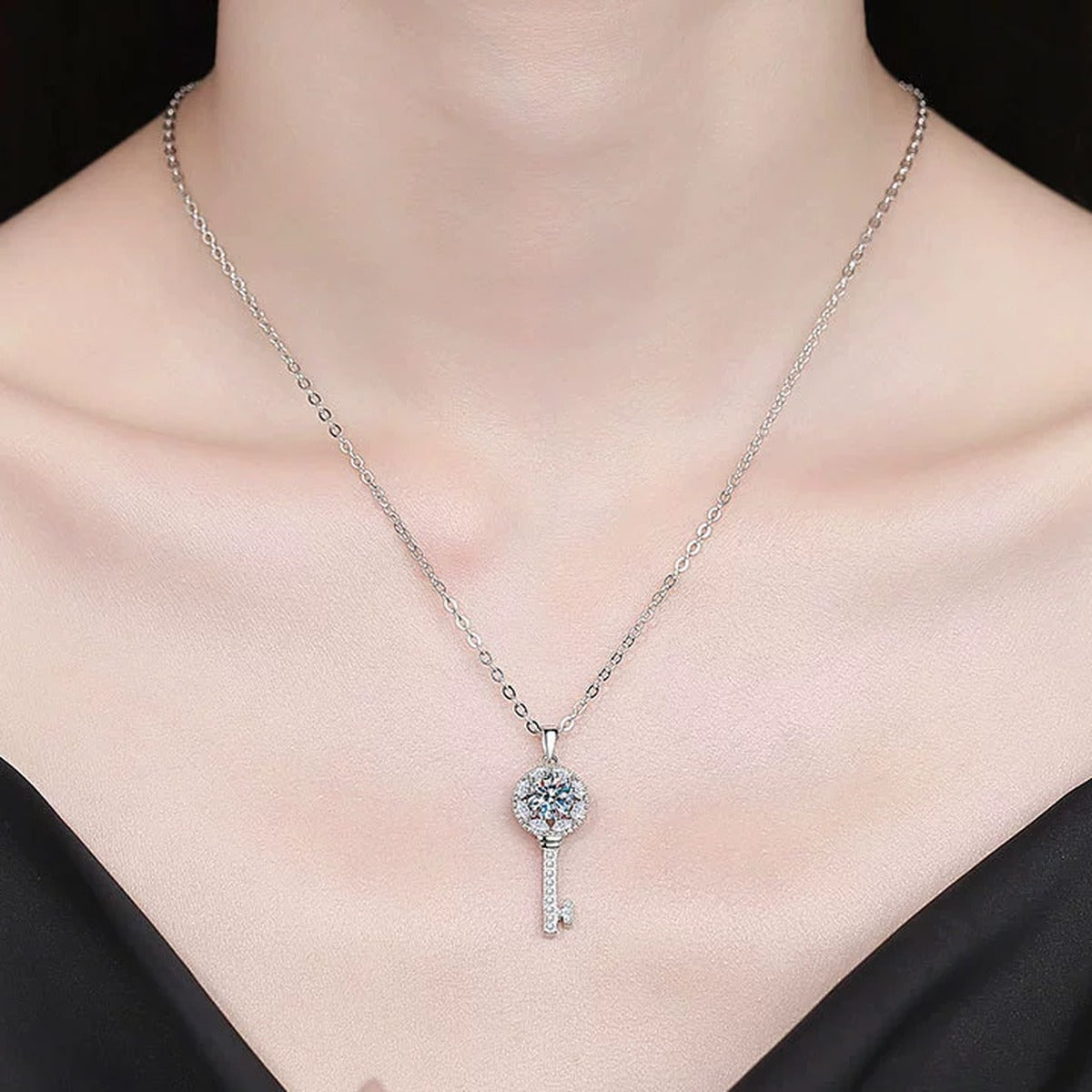 Teardrop Halo Moissanite Pendant Necklace with Cubic Zirconia in Platinum-Plated S925 Sterling Silver worn on neckline by model