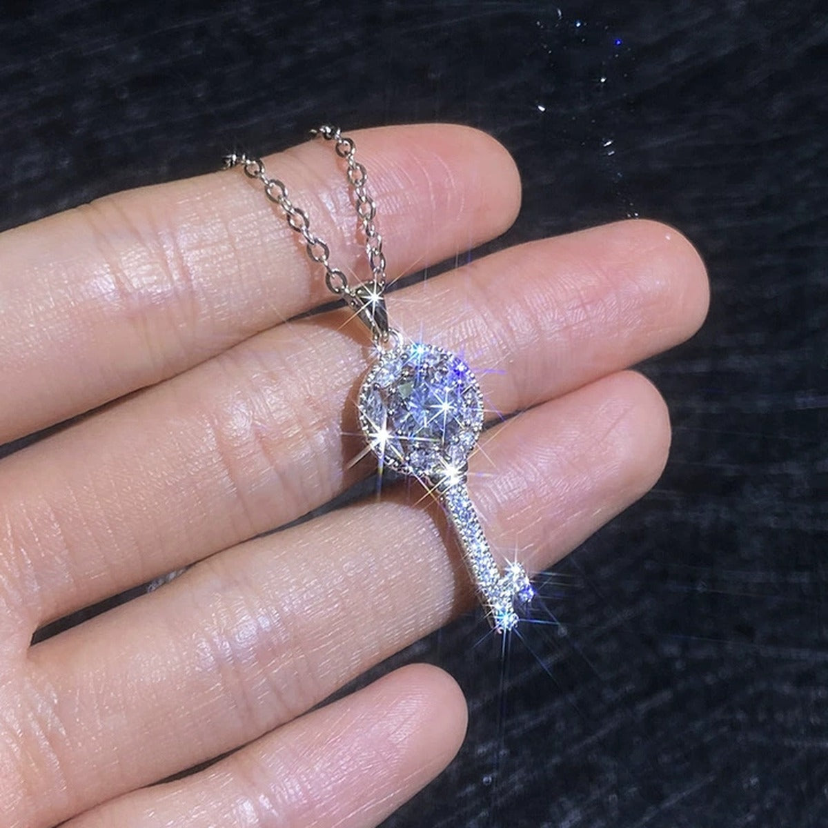 Teardrop Halo Moissanite Pendant Necklace with Cubic Zirconia in Platinum-Plated S925 Sterling Silver worn on neckline by model