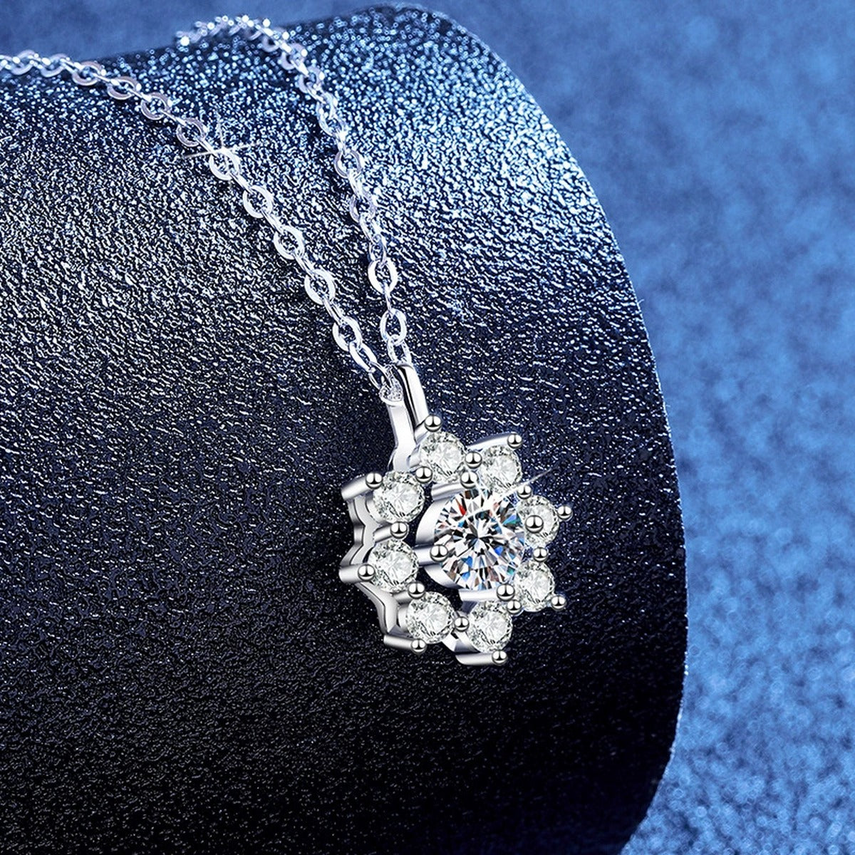 Knot Moissanite Pendant Necklace with Cubic Zirconia in Platinum-Plated S925 Sterling Silver blue background angled view