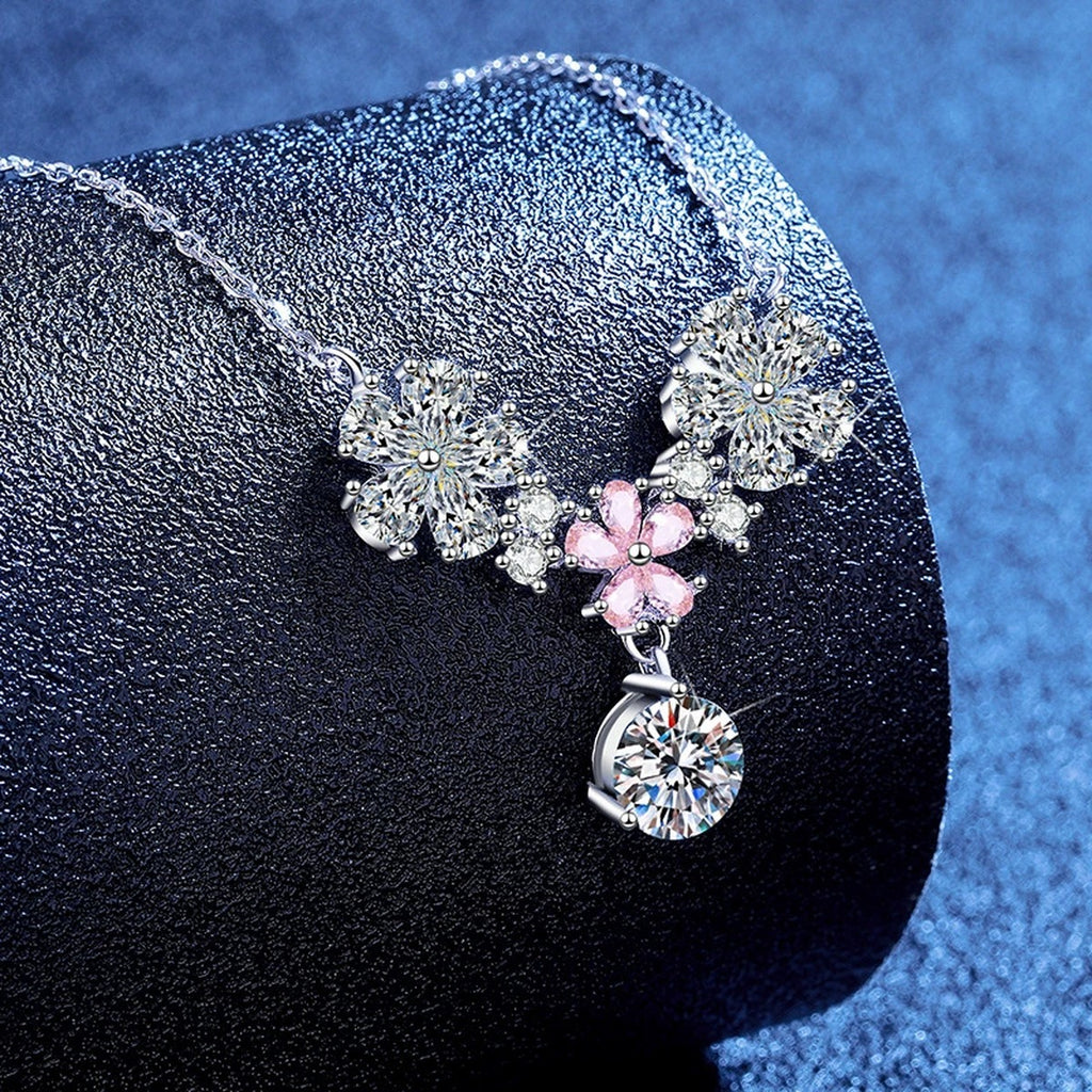 Floral Moissanite Pendant Necklace with Pink Cubic Zirconia in Platinum-Plated S925 Sterling Silver blue background angled view