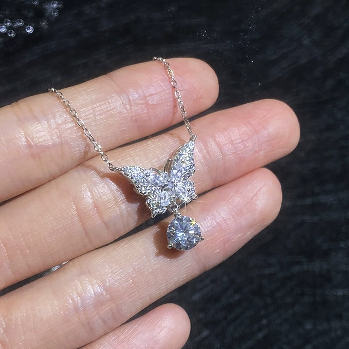 Butterfly Moissanite Pendant Necklace with Cubic Zirconia in Platinum-Plated S925 Sterling Silver worn on neckline by model