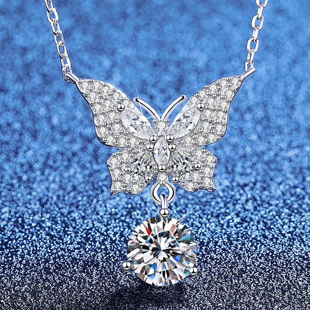 Butterfly Moissanite Pendant Necklace with Cubic Zirconia in Platinum-Plated S925 Sterling Silver blue background angled view