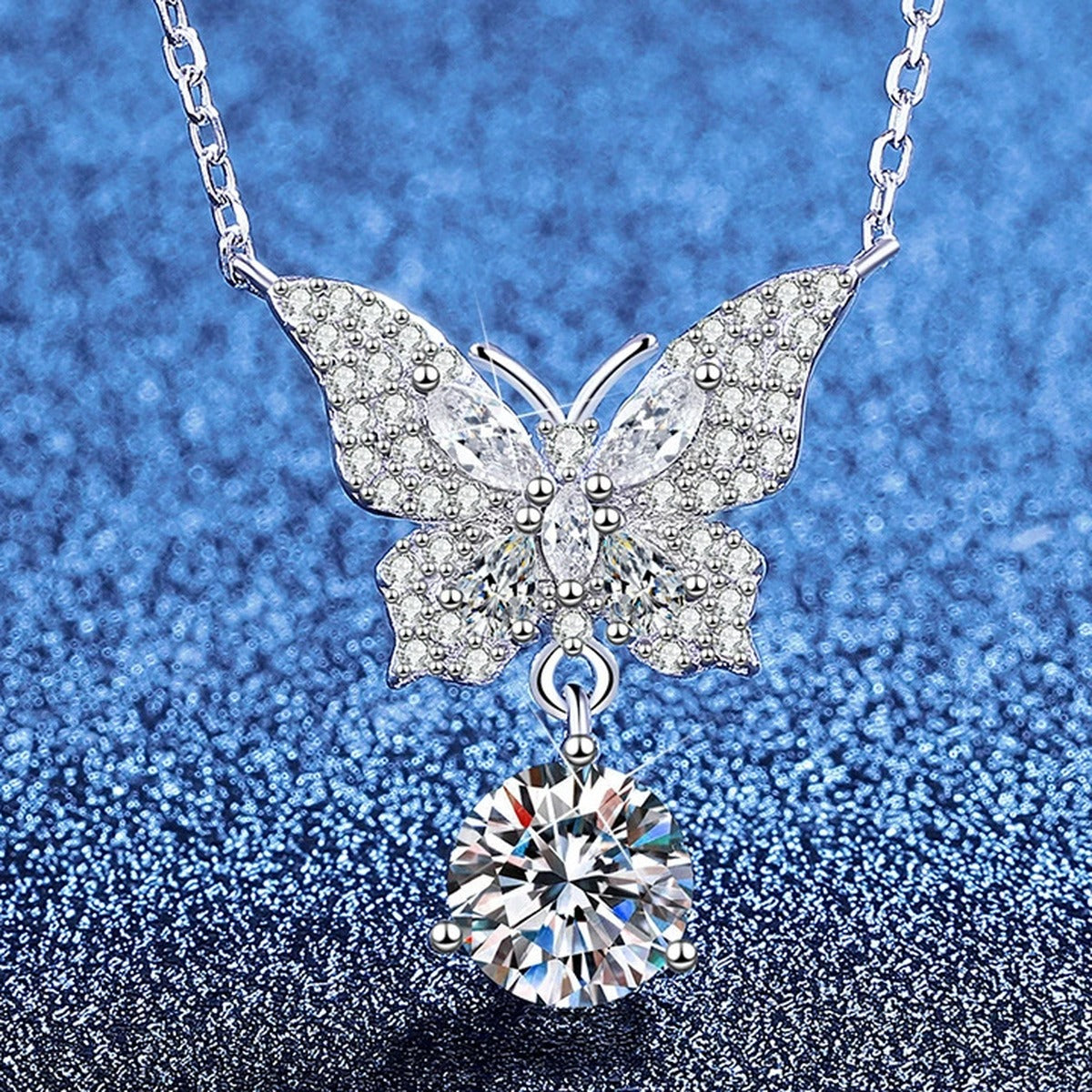 Butterfly Moissanite Pendant Necklace with Cubic Zirconia in Platinum-Plated S925 Sterling Silver blue background angled view