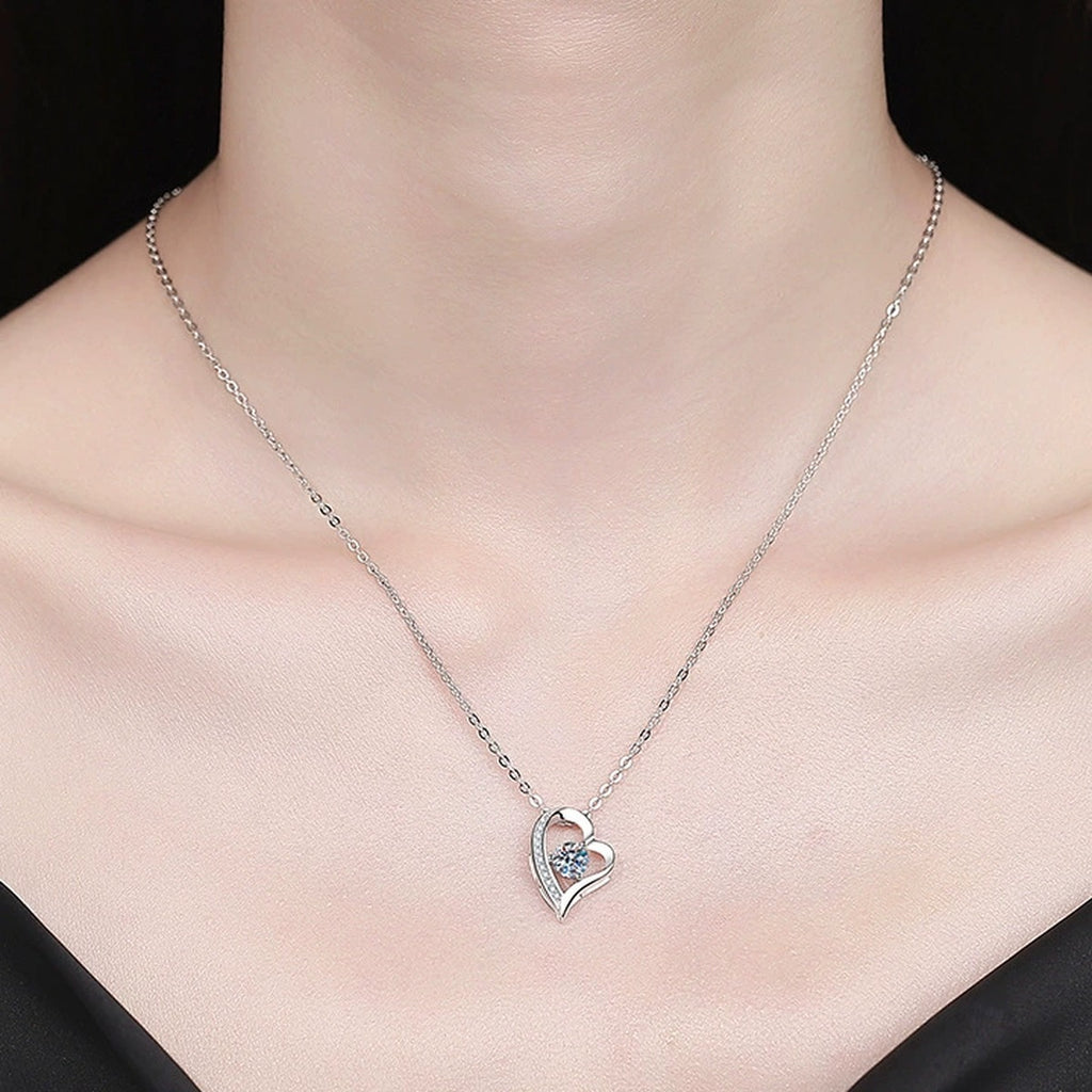 Heart Knot Moissanite Pendant Necklace with Cubic Zirconia in Platinum-Plated S925 Sterling Silver worn on neckline by model