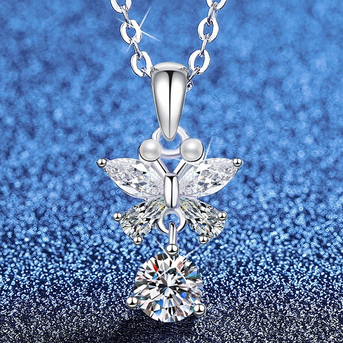 Star Cross Moissanite Pendant Necklace with Cubic Zirconia in Platinum-Plated S925 Sterling Silver blue background angled view