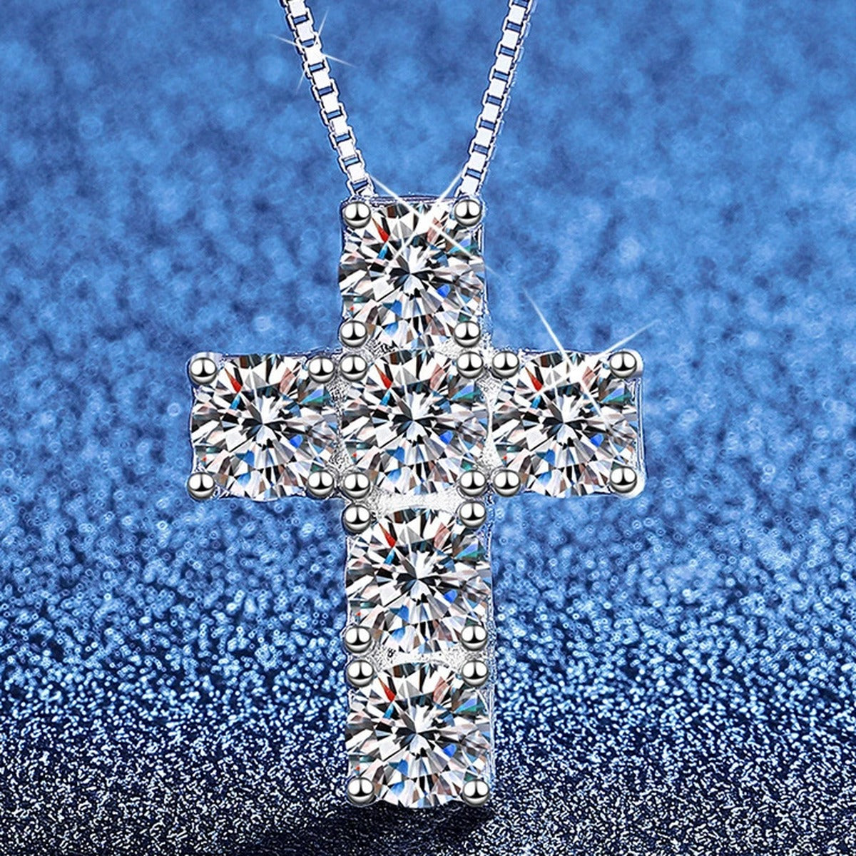 Cross Moissanite Pendant Necklace in Platinum-Plated S925 Sterling Silver blue background angled view